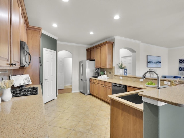 kitchen featuring sink, ornamental molding, kitchen peninsula, light stone countertops, and black appliances