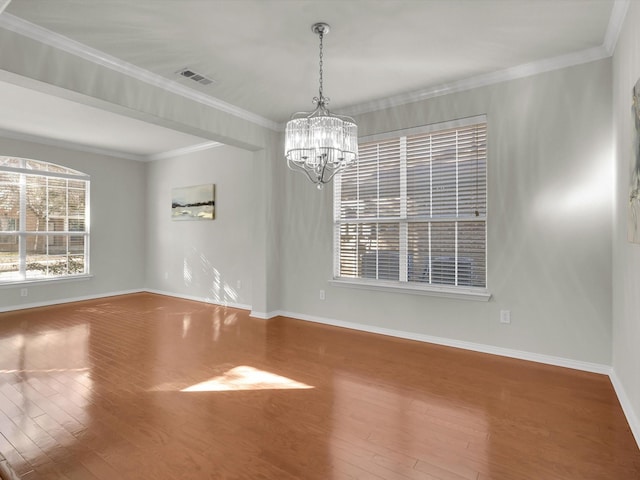 empty room with an inviting chandelier, wood-type flooring, and crown molding