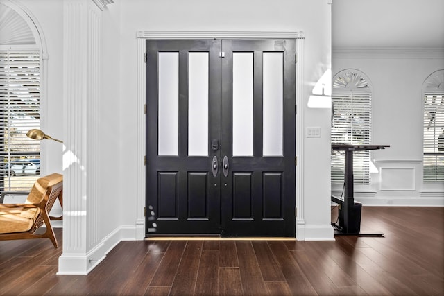 foyer with ornamental molding and dark wood-type flooring