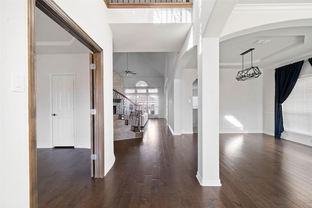 entrance foyer with ceiling fan, dark hardwood / wood-style flooring, and a raised ceiling