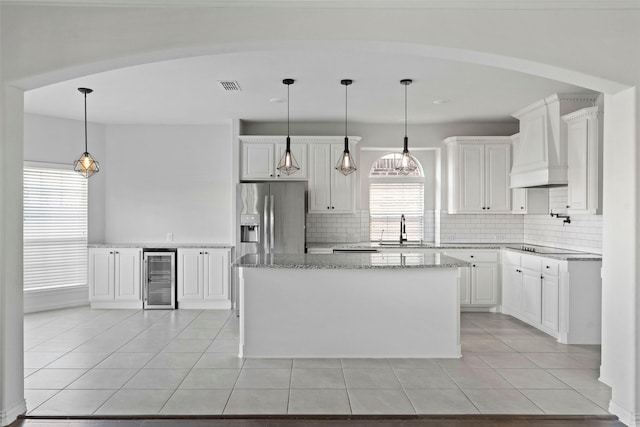 kitchen featuring white cabinetry, a kitchen island, and backsplash