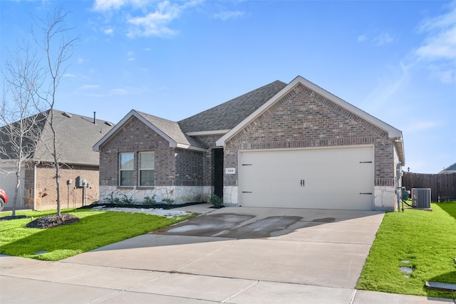 view of front of property featuring a garage, a front yard, and cooling unit