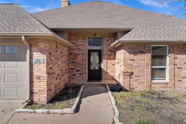 doorway to property with a garage