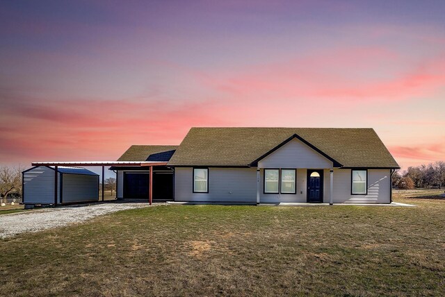 ranch-style home with a carport and a yard