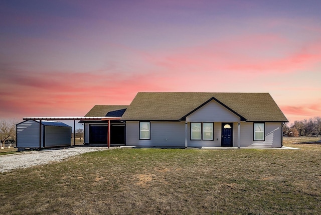 ranch-style home with a yard and a carport