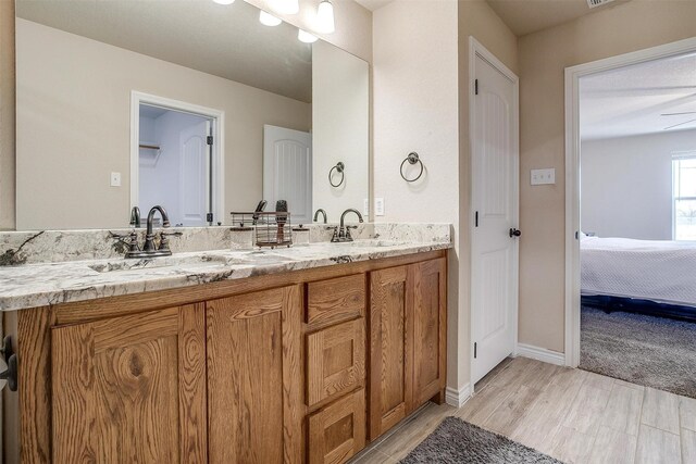 bathroom with vanity, toilet, hardwood / wood-style floors, and a textured ceiling