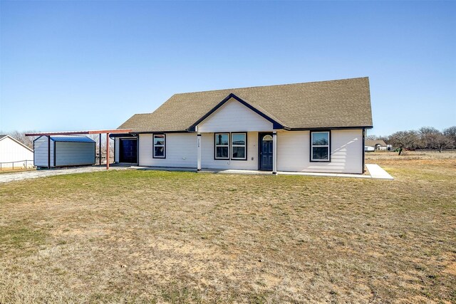 single story home with a storage shed and a front lawn