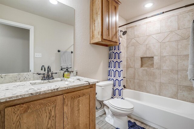 full bathroom featuring hardwood / wood-style flooring, a textured ceiling, and toilet