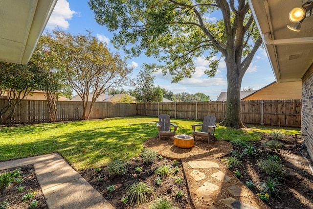 view of yard with a fire pit