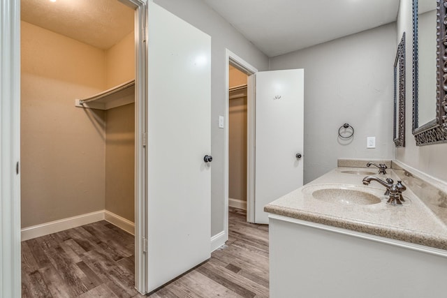 bathroom with vanity and hardwood / wood-style floors