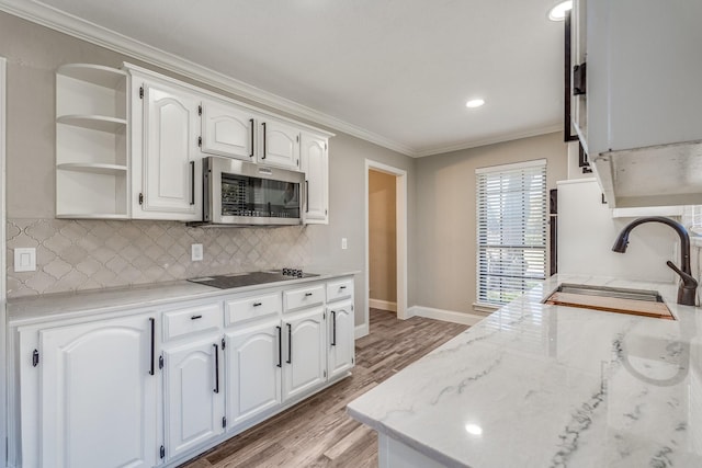 kitchen with white cabinetry, sink, crown molding, and black electric cooktop