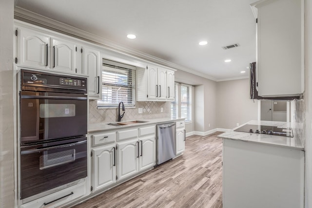 kitchen featuring crown molding, sink, white cabinets, and black appliances