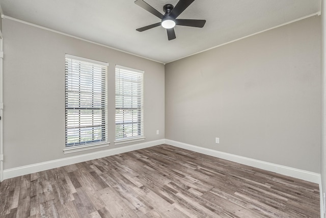 spare room with hardwood / wood-style floors, crown molding, and ceiling fan