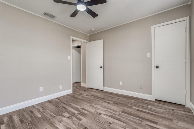 unfurnished bedroom with crown molding, light hardwood / wood-style flooring, and ceiling fan