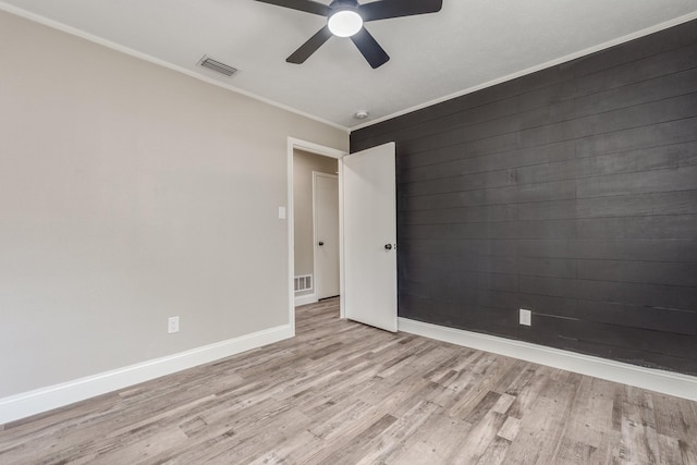 unfurnished room featuring ornamental molding, ceiling fan, and light hardwood / wood-style flooring