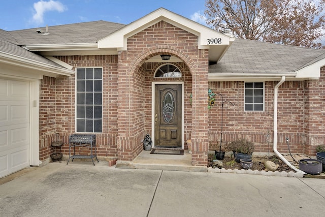 doorway to property with a garage