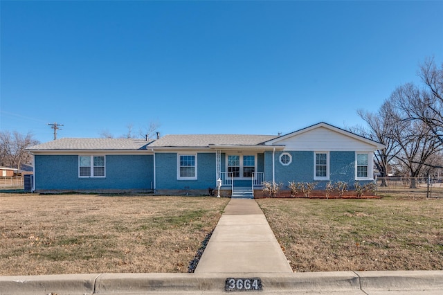 ranch-style home with a front yard and covered porch