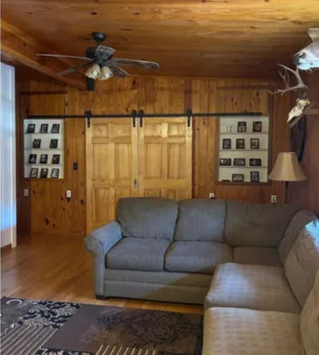 living room featuring wood ceiling, wooden walls, and hardwood / wood-style floors