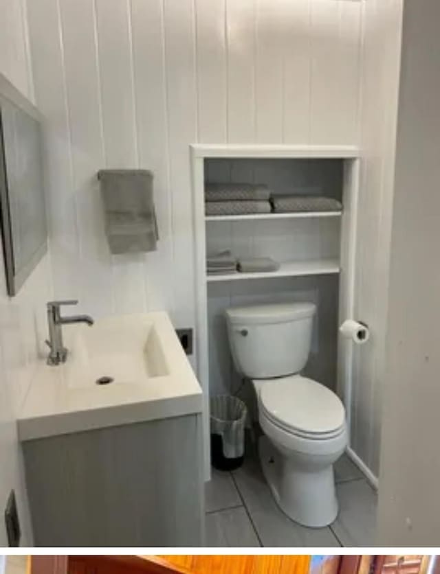 bathroom with vanity, tile patterned floors, and toilet