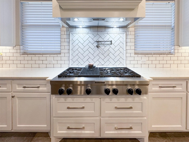 kitchen featuring tasteful backsplash, stainless steel gas cooktop, and white cabinets