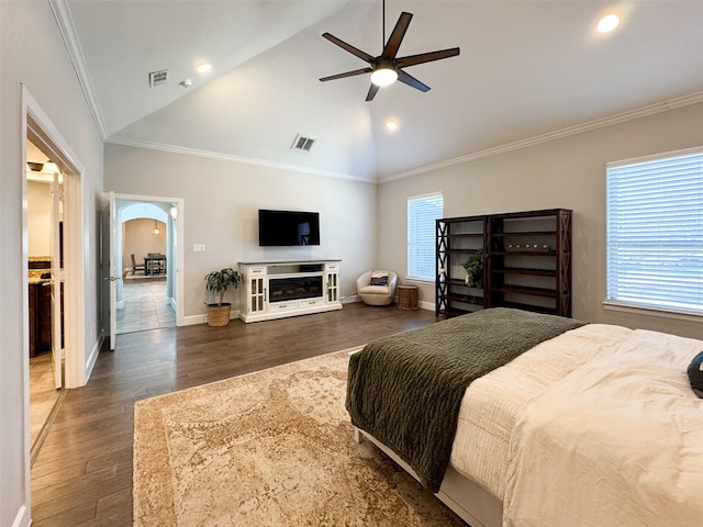 bedroom with ornamental molding, lofted ceiling, dark hardwood / wood-style floors, and ceiling fan