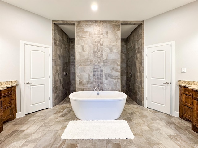 bathroom featuring vanity and a washtub