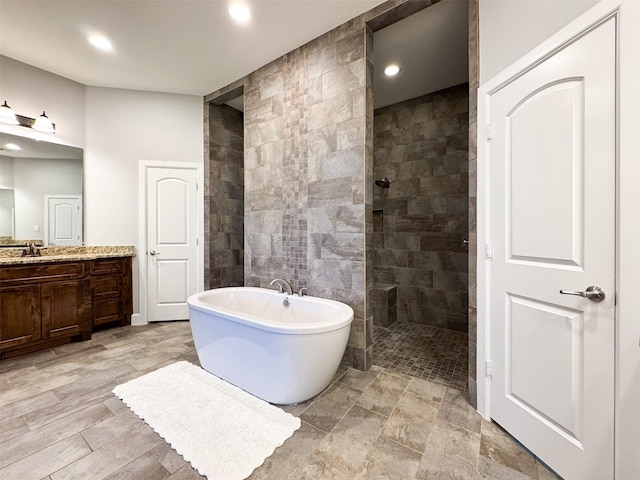 bathroom with vanity and separate shower and tub