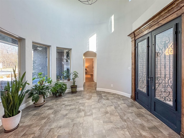 entryway with french doors and a high ceiling