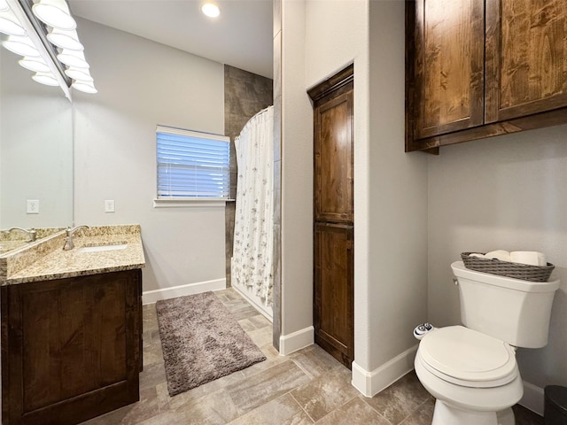 bathroom featuring vanity, a shower with shower curtain, and toilet