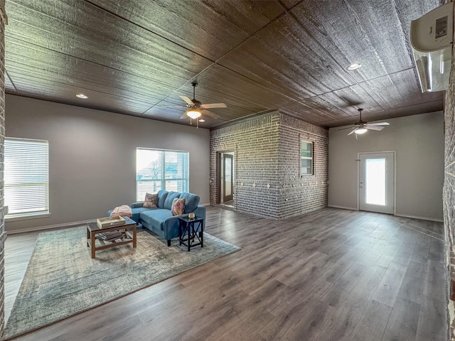 unfurnished living room featuring wood ceiling, wood-type flooring, a wealth of natural light, and brick wall