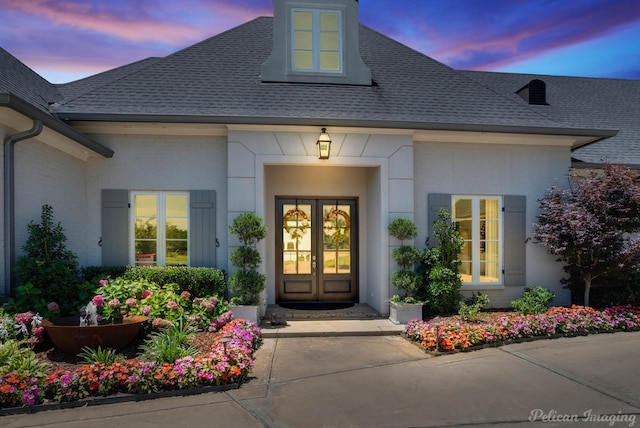 exterior entry at dusk with french doors