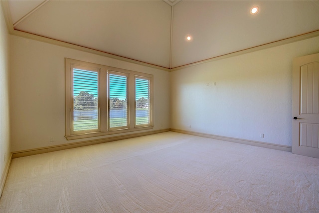 empty room featuring crown molding, lofted ceiling, and light colored carpet