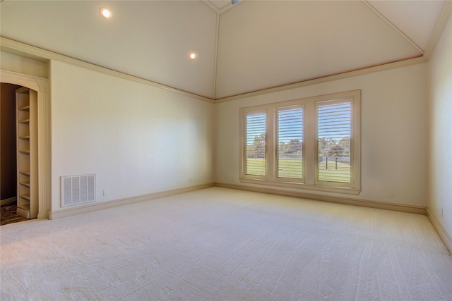 spare room with vaulted ceiling and light colored carpet