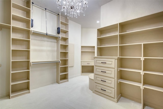 walk in closet with light carpet and a notable chandelier