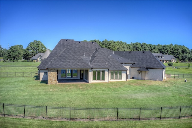 rear view of property featuring a yard