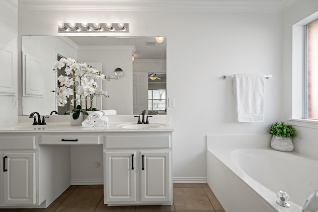 bathroom with a tub to relax in, tile patterned floors, vanity, and plenty of natural light