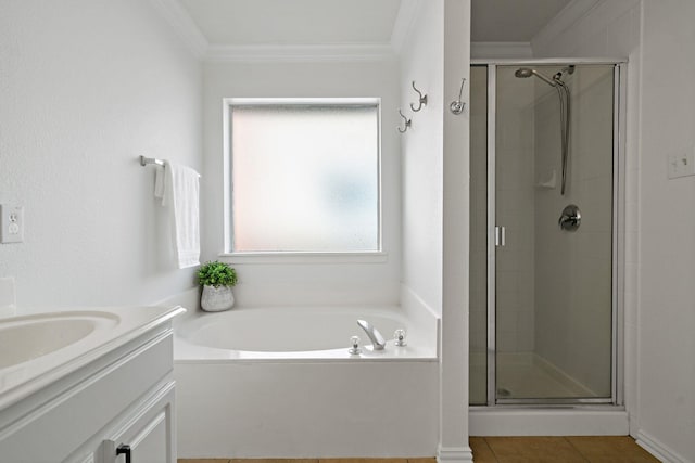 bathroom featuring vanity, ornamental molding, and separate shower and tub