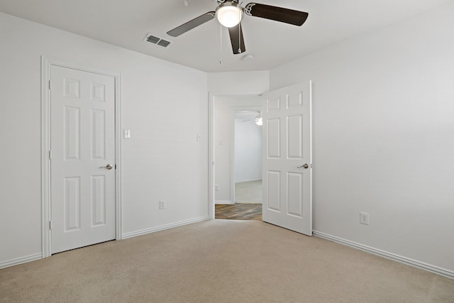 unfurnished bedroom with light carpet and ceiling fan