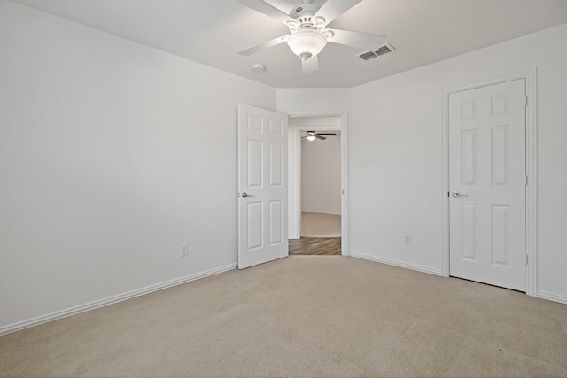 unfurnished bedroom featuring light carpet and ceiling fan