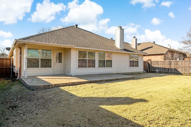 back of house featuring a patio and a yard