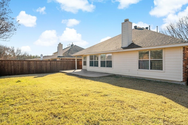 back of property featuring a yard and a patio area