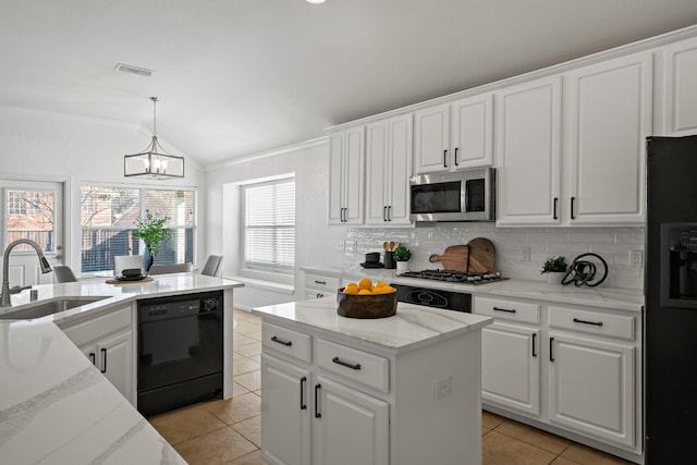 kitchen with lofted ceiling, sink, hanging light fixtures, black appliances, and white cabinets