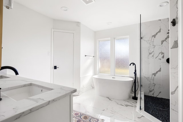 full bathroom featuring marble finish floor, a marble finish shower, double vanity, recessed lighting, and a soaking tub