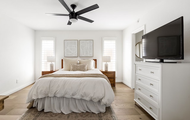 bedroom with baseboards, ceiling fan, and light wood-style floors