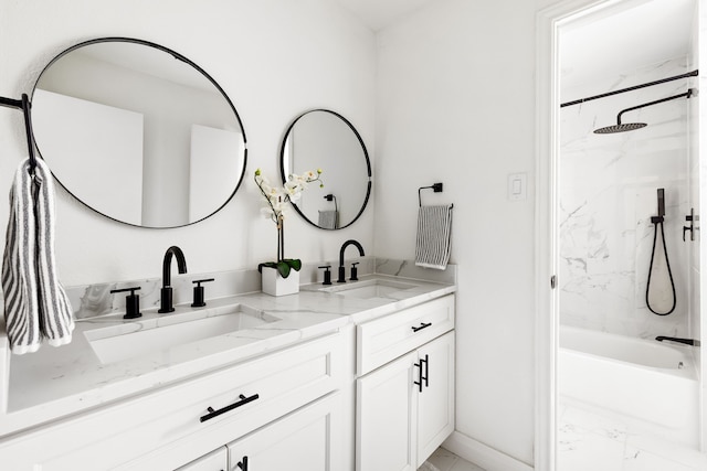 full bathroom with marble finish floor, double vanity, a sink, and washtub / shower combination