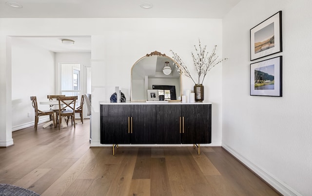 bar with baseboards and hardwood / wood-style floors