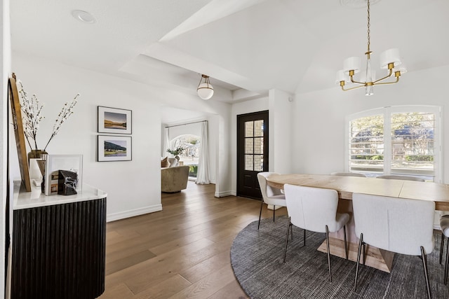 dining space featuring dark hardwood / wood-style floors and a notable chandelier