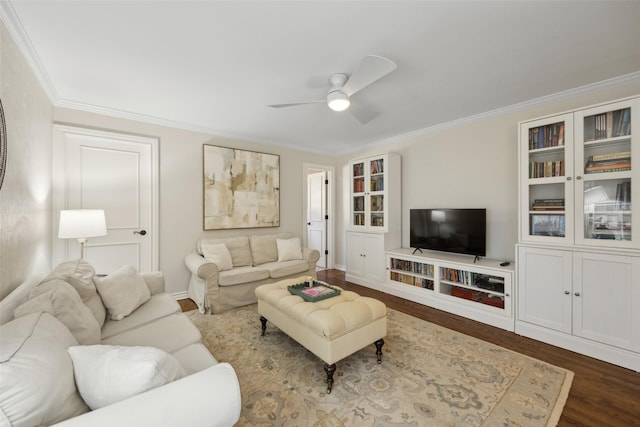 living room featuring wood-type flooring, ornamental molding, and ceiling fan