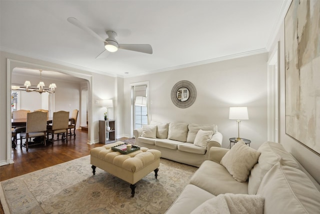 living room featuring crown molding, ceiling fan with notable chandelier, and dark hardwood / wood-style floors