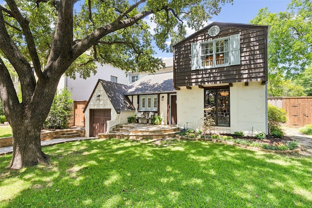 view of front of property with an outbuilding, a garage, and a front yard